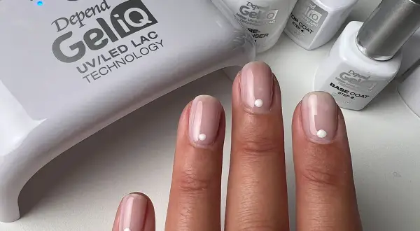 Fina gelenaglar med en vit prick, redo att måla nagellack. Depend GeliQ UV/LED-lampa och produkter syns i bakgrunden.